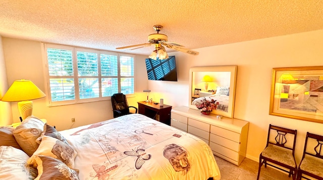 bedroom featuring ceiling fan and a textured ceiling