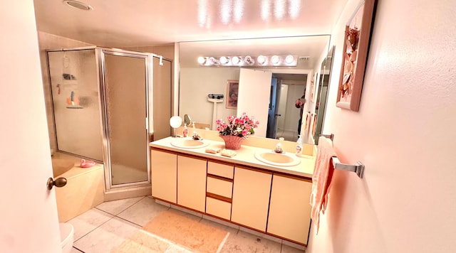 bathroom with tile patterned flooring, vanity, and bath / shower combo with glass door