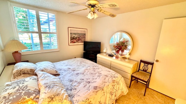 bedroom with light tile patterned floors, a textured ceiling, and ceiling fan