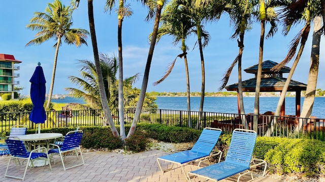 view of patio with a gazebo and a water view