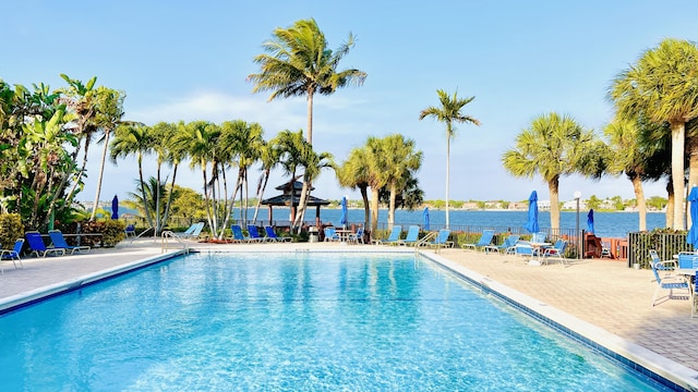 view of pool featuring a gazebo, a water view, and a patio area