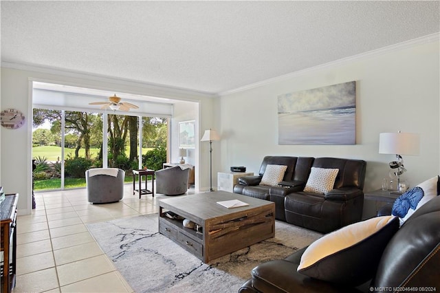 tiled living room with ceiling fan, ornamental molding, and a textured ceiling