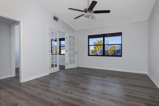 spare room with a textured ceiling, vaulted ceiling, french doors, ceiling fan, and dark hardwood / wood-style flooring