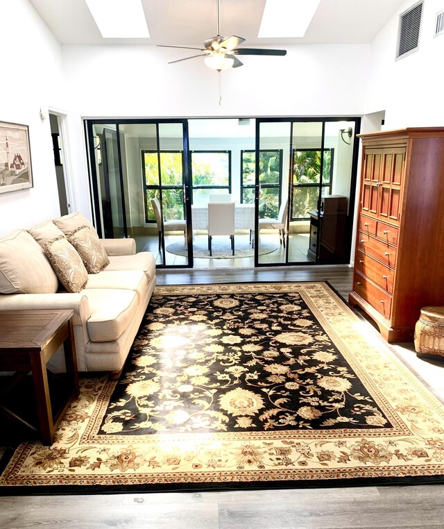 unfurnished living room featuring ceiling fan, vaulted ceiling, and light tile patterned flooring