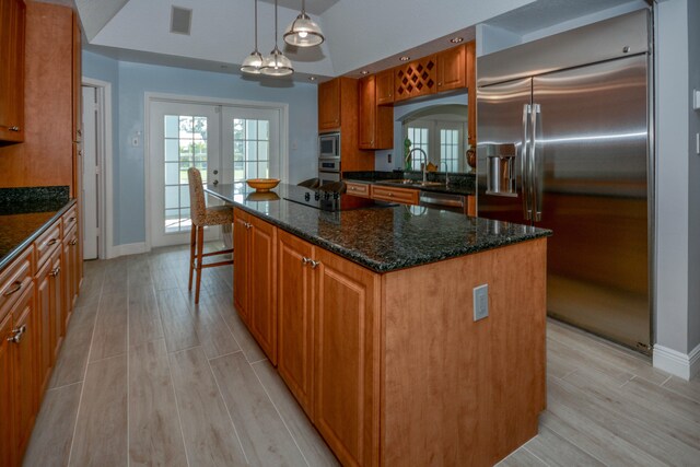 unfurnished sunroom featuring ceiling fan and french doors