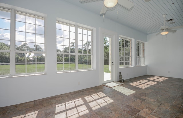 unfurnished sunroom with ceiling fan