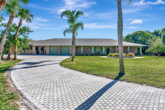 single story home with a garage and a front yard