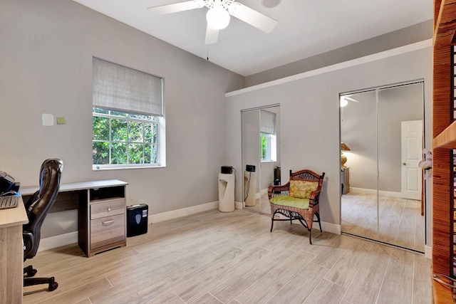 office space with ceiling fan and light wood-type flooring