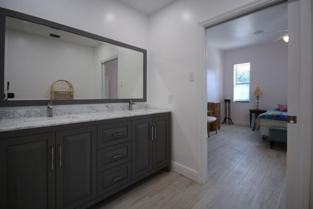 bathroom featuring tile walls, a shower with door, vanity, and toilet