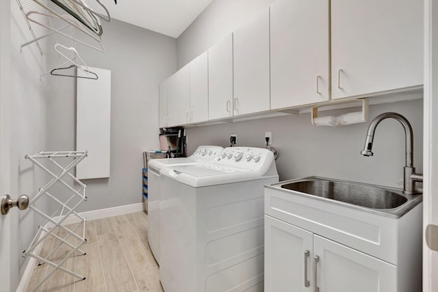 laundry room featuring sink, cabinets, and washer and dryer