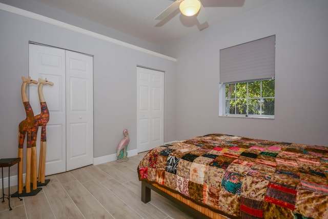 bedroom with two closets and ceiling fan