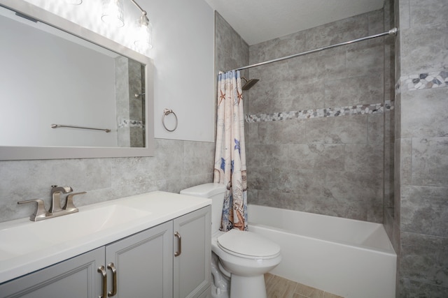 full bathroom featuring tile walls, hardwood / wood-style floors, vanity, shower / bath combination with curtain, and toilet