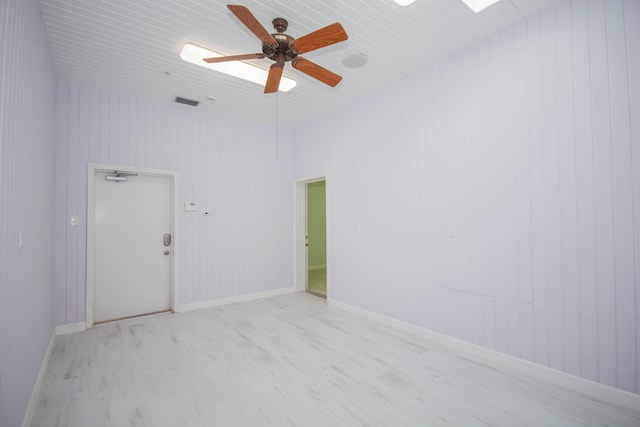 empty room with ceiling fan and light wood-type flooring