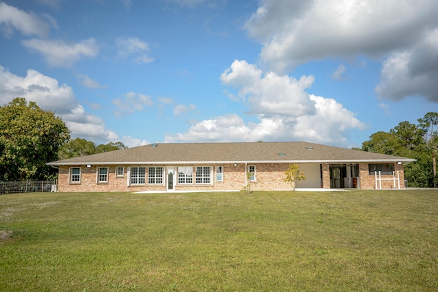 back of house with a lawn