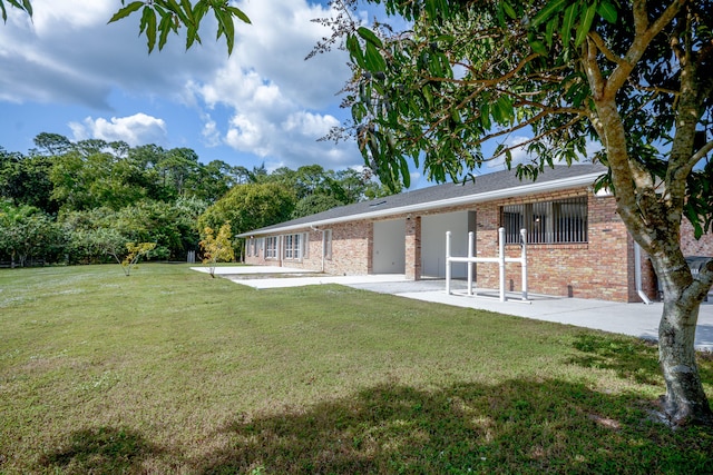 back of property featuring a yard and a patio