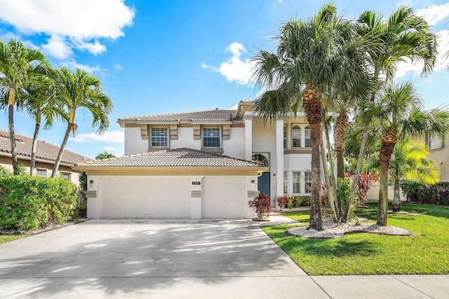 mediterranean / spanish house with a front lawn and a garage