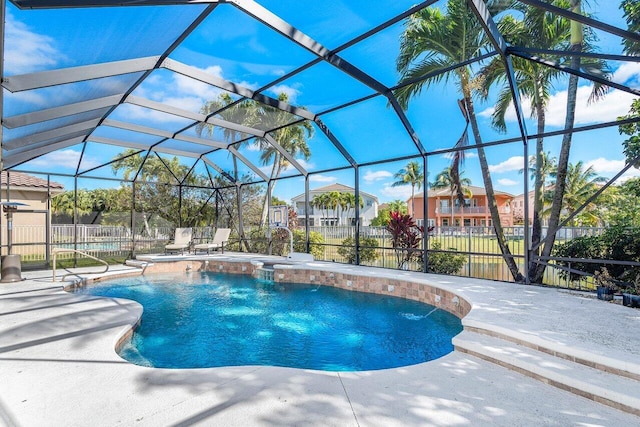 view of swimming pool featuring glass enclosure, a patio area, fence, and a fenced in pool