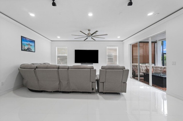 living room with ceiling fan, light tile patterned floors, and ornamental molding