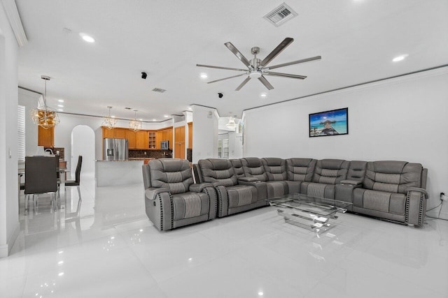 tiled living room featuring ceiling fan and crown molding