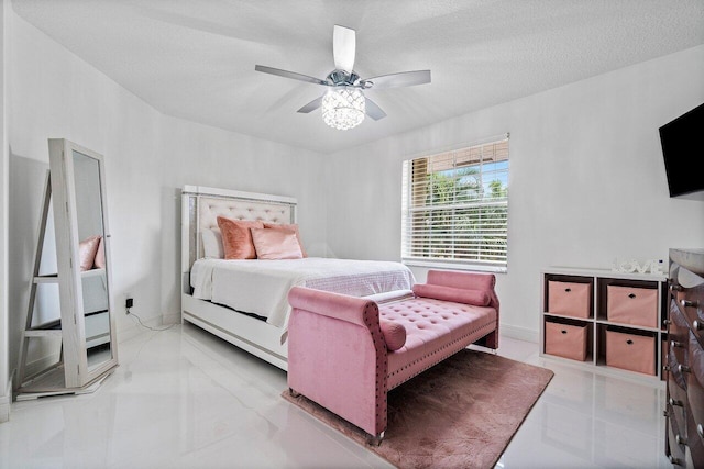 bedroom featuring ceiling fan and a textured ceiling