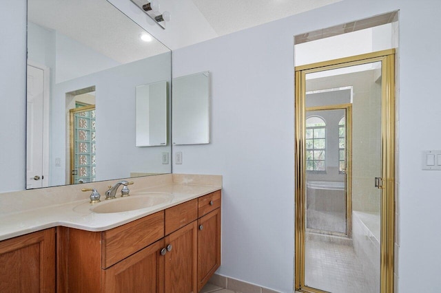 full bathroom with a shower stall and vanity