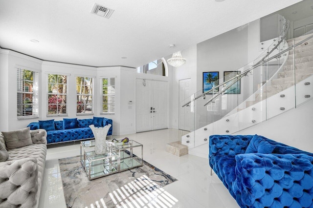 living room featuring a textured ceiling and an inviting chandelier