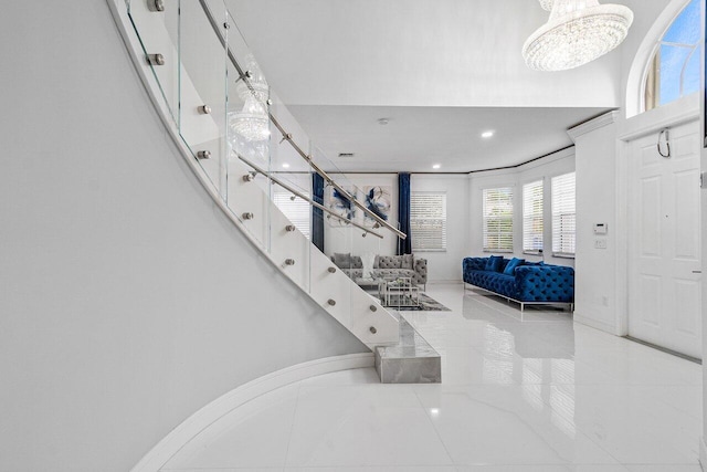 tiled foyer featuring a chandelier