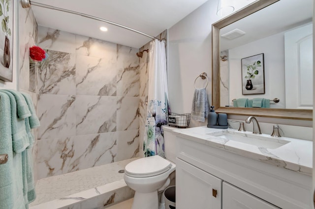 bathroom with toilet, vanity, and a shower with curtain