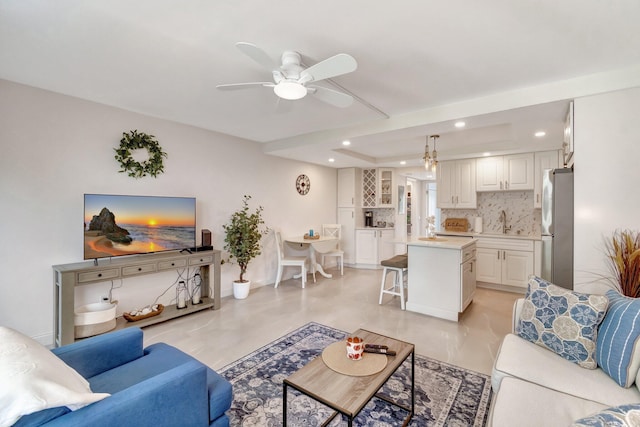 living room with ceiling fan and sink