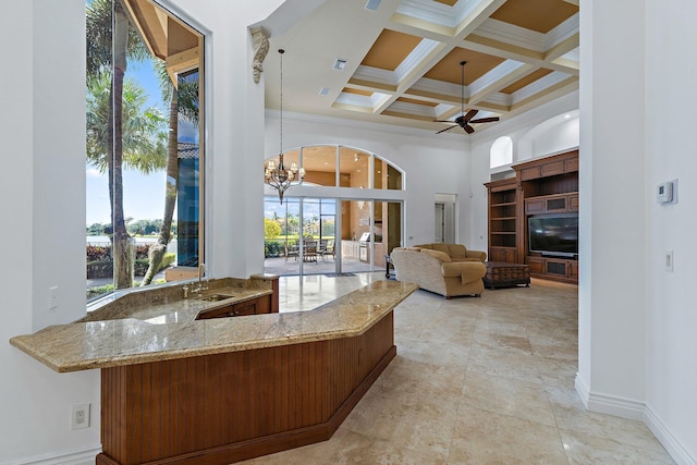 135 Playa Rienta Way, Palm Beach Gardens, FL 33418 - kitchen with light stone countertops, beamed ceiling, coffered ceiling, crown molding, and a ceiling fan