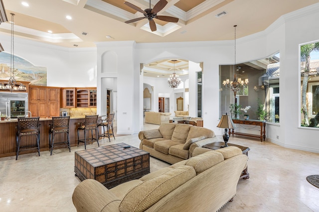 living room with ornamental molding, coffered ceiling, a towering ceiling, and ceiling fan with notable chandelier