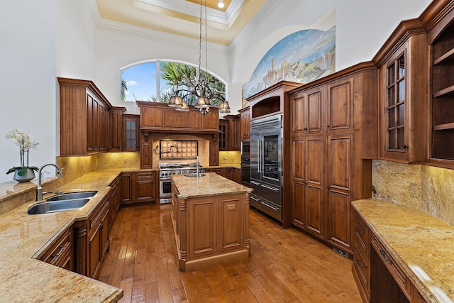 135 Playa Rienta Way, Palm Beach Gardens, FL 33418 - kitchen featuring a sink, high quality appliances, a towering ceiling, ornamental molding, and light stone countertops