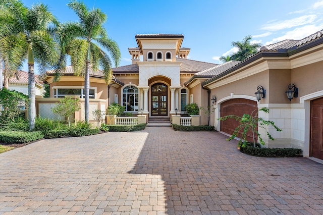 mediterranean / spanish-style house featuring french doors and a garage