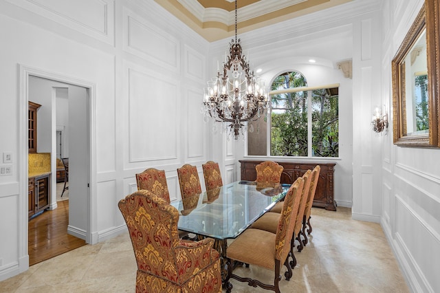 135 Playa Rienta Way, Palm Beach Gardens, FL 33418 - dining room featuring a decorative wall, a chandelier, beverage cooler, light tile patterned flooring, and ornamental molding
