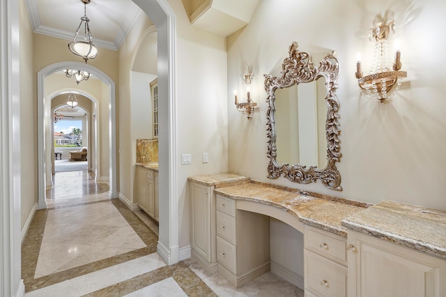 135 Playa Rienta Way, Palm Beach Gardens, FL 33418 - bathroom with inlaid floor details, marble tiled floors, crown molding, vanity, and baseboards