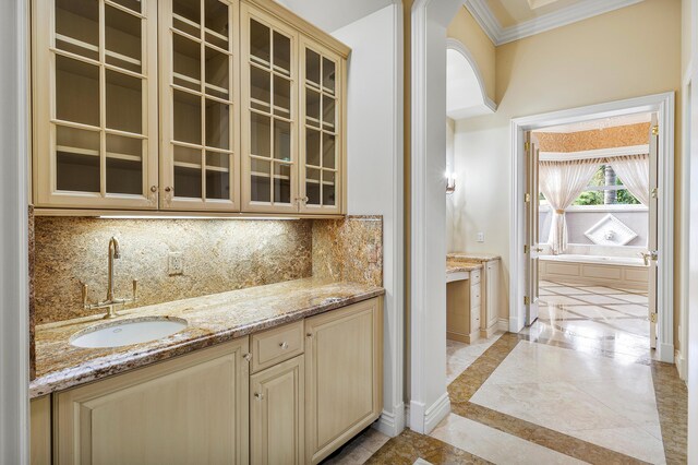 bathroom featuring ornamental molding, a bath, a towering ceiling, and vanity