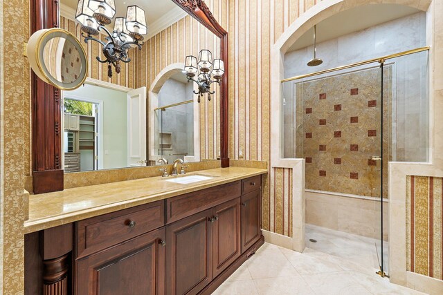135 Playa Rienta Way, Palm Beach Gardens, FL 33418 - bathroom featuring a chandelier, wallpapered walls, a shower stall, vanity, and tile patterned floors