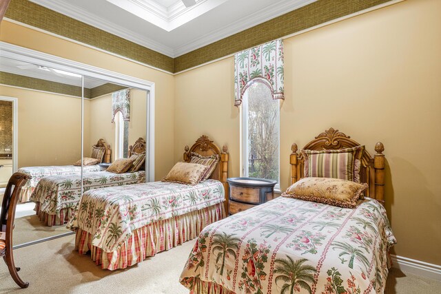 bedroom featuring a closet, ornamental molding, and carpet floors