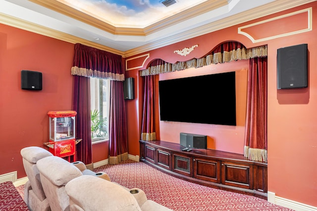 home theater room featuring crown molding, carpet flooring, and a tray ceiling