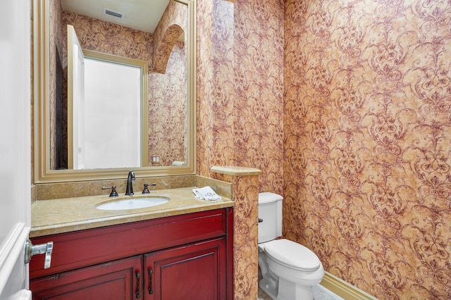 bathroom featuring toilet and vanity