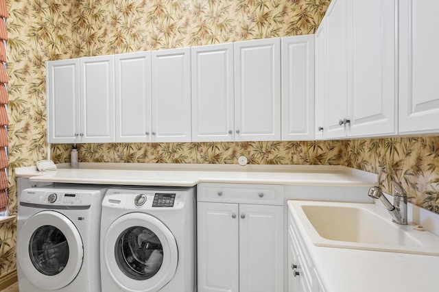 laundry room with sink, cabinets, and washer and clothes dryer