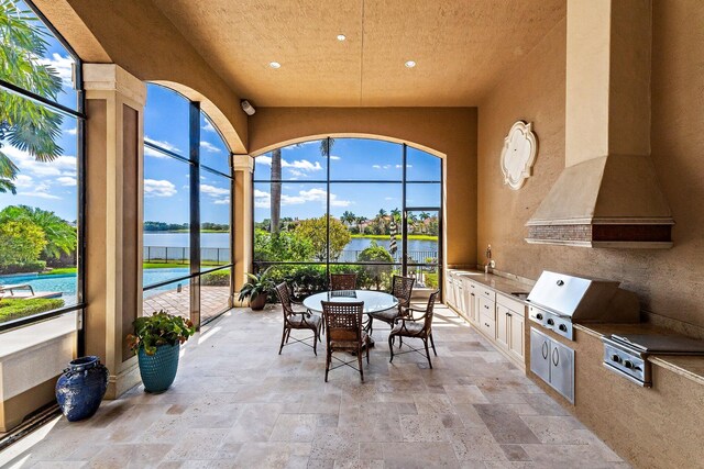 135 Playa Rienta Way, Palm Beach Gardens, FL 33418 - view of patio / terrace featuring a grill, a water view, and exterior kitchen