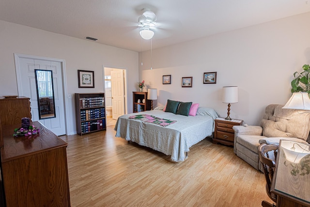 bedroom featuring ensuite bathroom, ceiling fan, and light hardwood / wood-style flooring