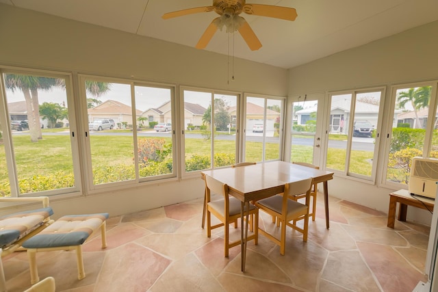 sunroom featuring lofted ceiling and ceiling fan