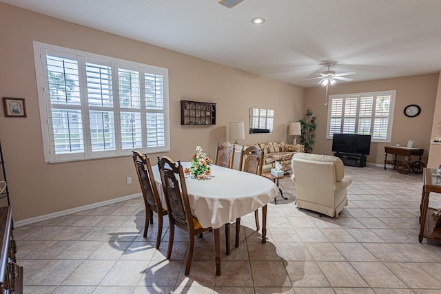 tiled dining space with ceiling fan