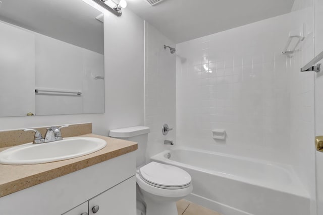 full bathroom with tile patterned floors, vanity, tiled shower / bath, and toilet