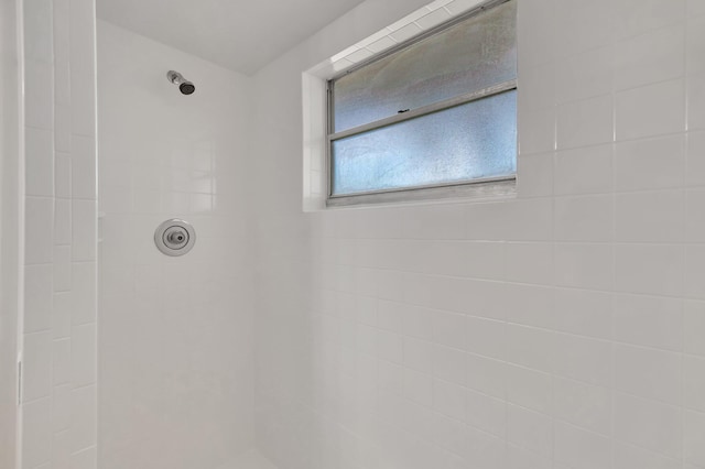 bathroom with tiled shower