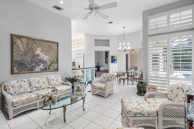 living room featuring ceiling fan with notable chandelier and light tile patterned floors