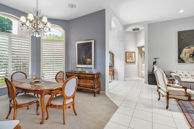 tiled dining space with a chandelier