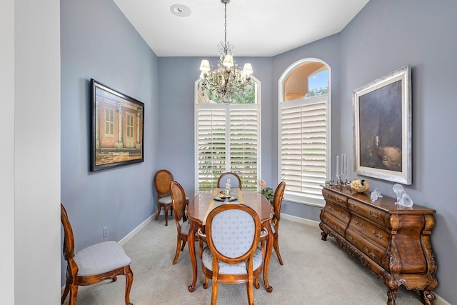 carpeted dining area with a notable chandelier